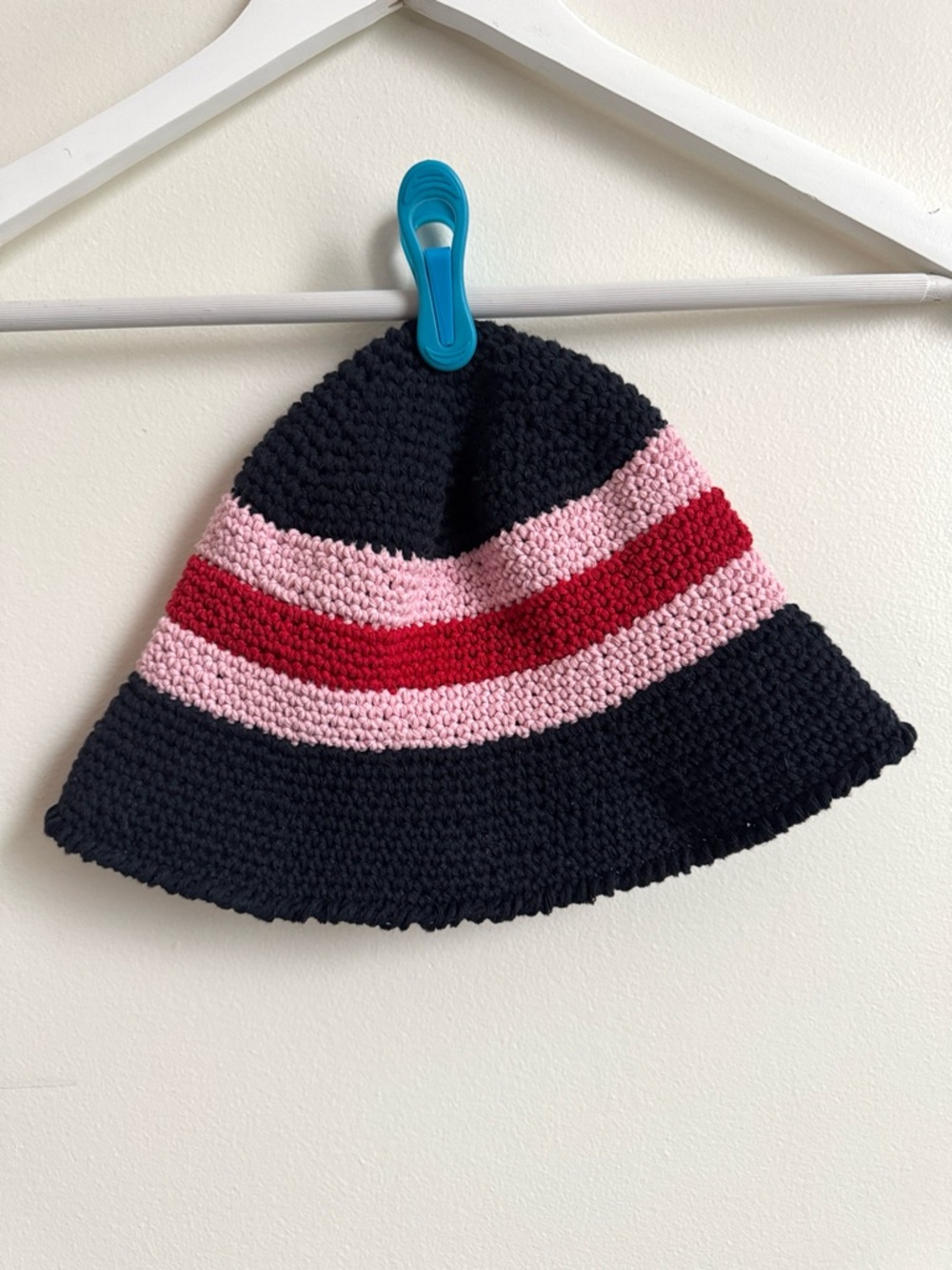 Bucket hat. Hand-crocheted in midnight blue, pink, and red cotton- poly blend.